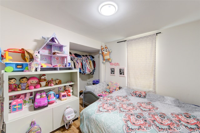 bedroom featuring wood finished floors and a closet