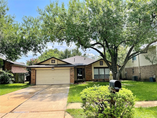 single story home featuring driveway, a front lawn, fence, an attached garage, and brick siding