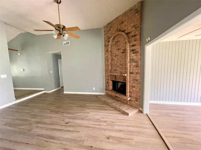 unfurnished living room with wood finished floors, baseboards, visible vents, lofted ceiling, and ceiling fan