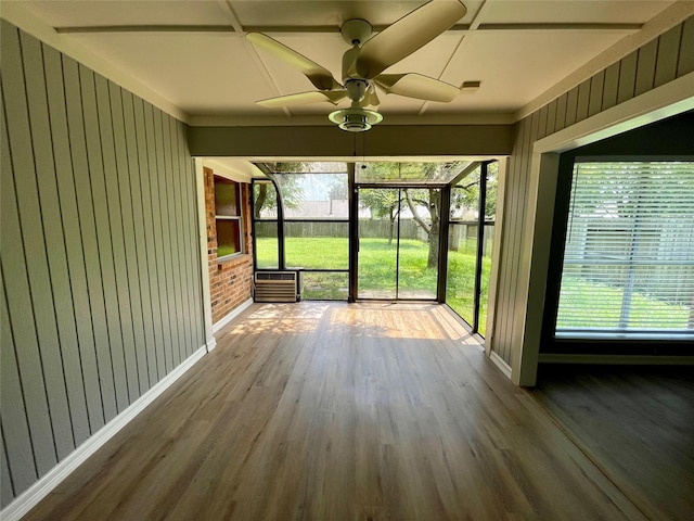 unfurnished sunroom with a ceiling fan