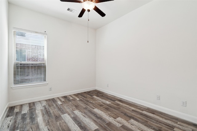 unfurnished room with visible vents, baseboards, ceiling fan, and wood finished floors