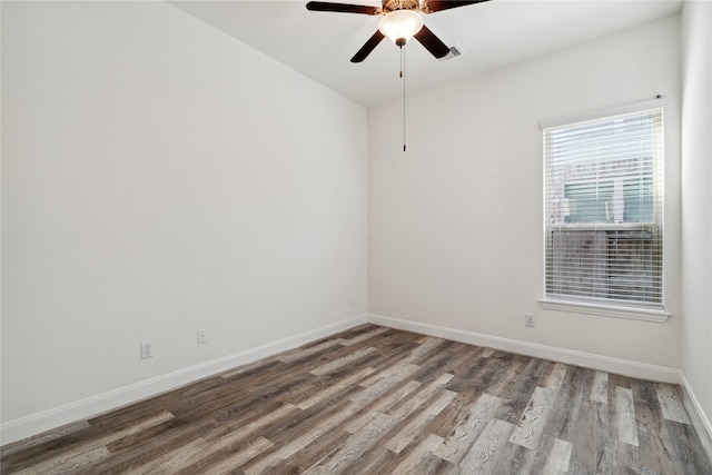 unfurnished room with baseboards, ceiling fan, and wood finished floors