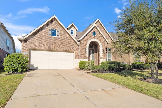 traditional-style home featuring a front yard, a garage, brick siding, and driveway