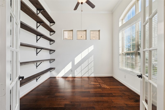 unfurnished room featuring hardwood / wood-style flooring, french doors, crown molding, baseboards, and ceiling fan