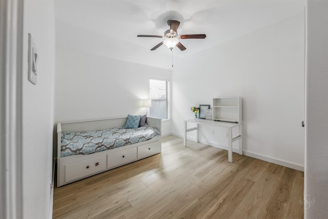 bedroom featuring a ceiling fan, baseboards, and wood finished floors