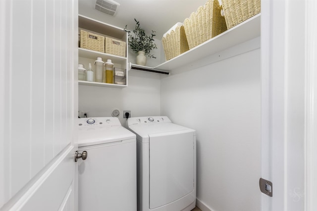 washroom featuring laundry area, visible vents, and independent washer and dryer