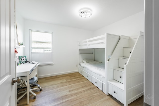 bedroom featuring baseboards and light wood-style floors