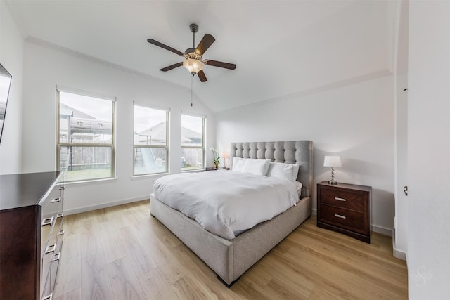 bedroom featuring ceiling fan, baseboards, ornamental molding, vaulted ceiling, and light wood-style floors