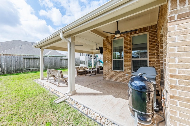 view of patio featuring grilling area, fence private yard, and a ceiling fan