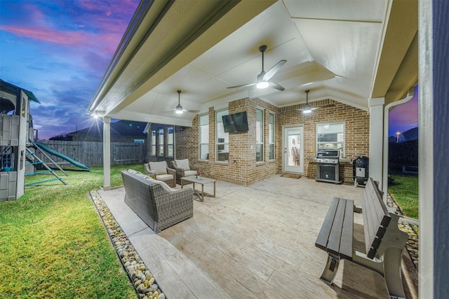 view of patio with a ceiling fan, a fenced backyard, a playground, grilling area, and an outdoor hangout area