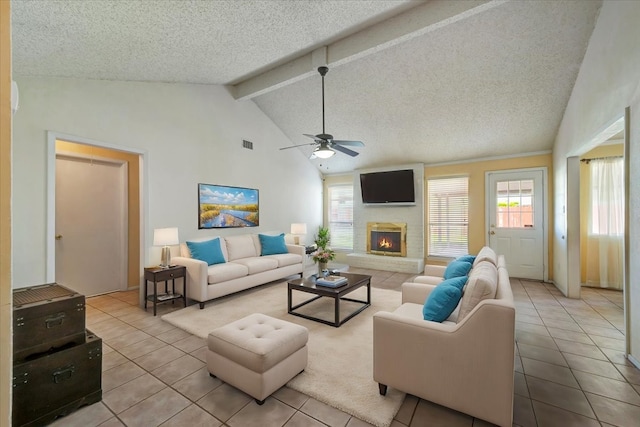 living room with a textured ceiling, beamed ceiling, visible vents, and ceiling fan