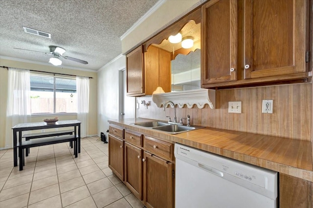 kitchen featuring a sink, visible vents, brown cabinetry, and white dishwasher