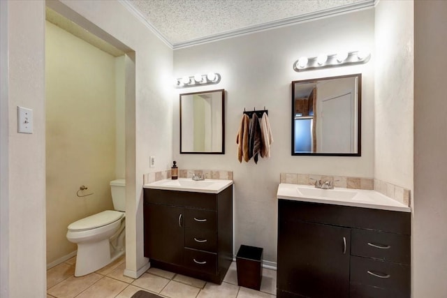 bathroom with tile patterned flooring, toilet, two vanities, and crown molding