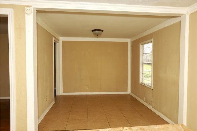 corridor featuring light tile patterned flooring, crown molding, and baseboards