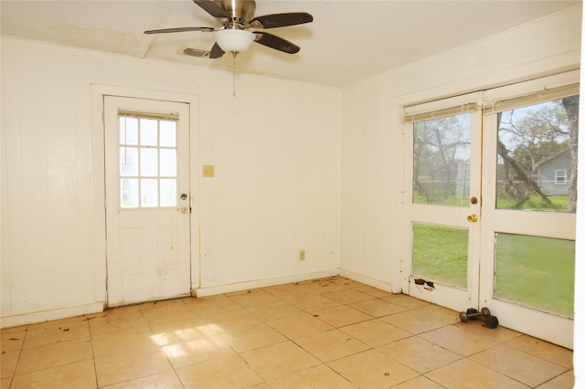 empty room with visible vents, baseboards, and a ceiling fan