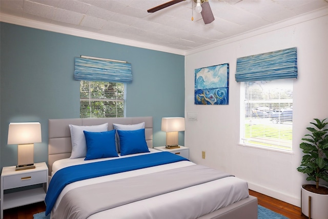 bedroom with ceiling fan, wood finished floors, baseboards, and ornamental molding