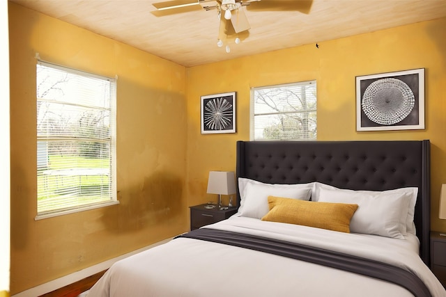 bedroom featuring multiple windows and a ceiling fan