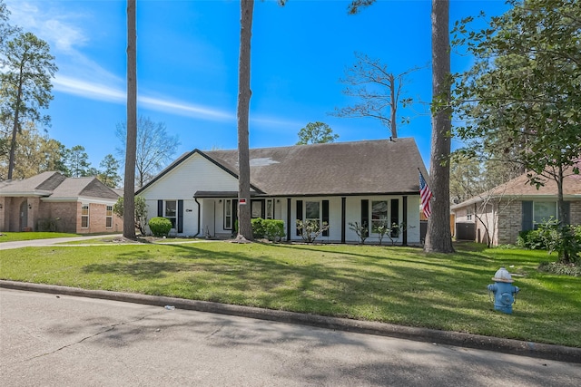 view of front of property with covered porch and a front yard