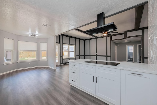 kitchen featuring black electric cooktop, dark wood-style floors, visible vents, wall chimney exhaust hood, and open floor plan