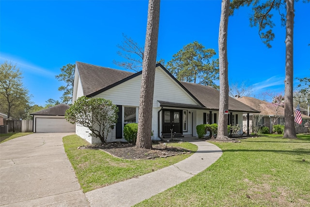 mid-century inspired home featuring a front yard, driveway, a porch, a shingled roof, and a garage