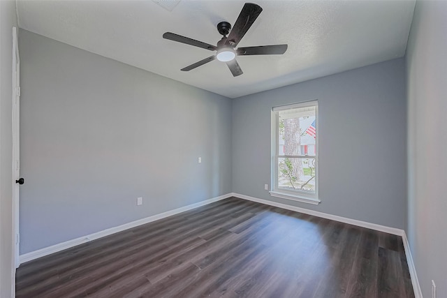 unfurnished room with baseboards, dark wood-type flooring, and a ceiling fan