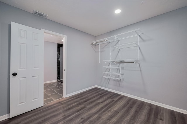 walk in closet featuring wood finished floors and visible vents