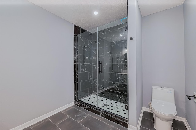 bathroom featuring baseboards, a marble finish shower, a textured ceiling, tile patterned floors, and toilet