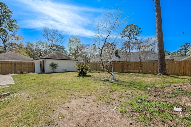 view of yard featuring an outbuilding and a fenced backyard