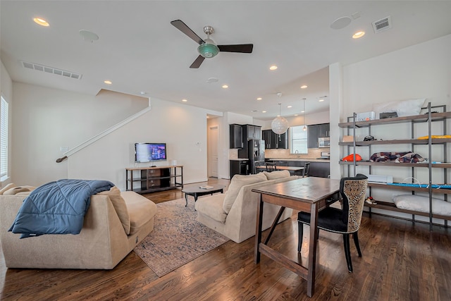 living area with visible vents, recessed lighting, dark wood-type flooring, and a ceiling fan