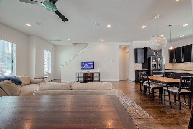 living area featuring visible vents, dark wood-type flooring, baseboards, ceiling fan, and recessed lighting