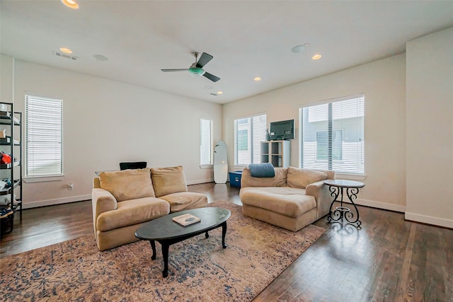 living room featuring dark wood finished floors, a ceiling fan, visible vents, and baseboards