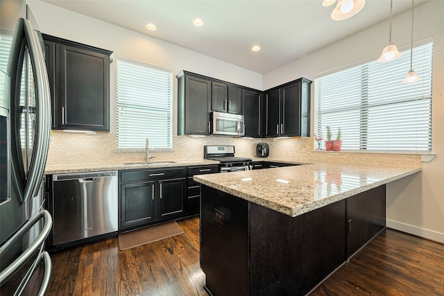 kitchen featuring backsplash, stainless steel appliances, dark wood-type flooring, and a sink