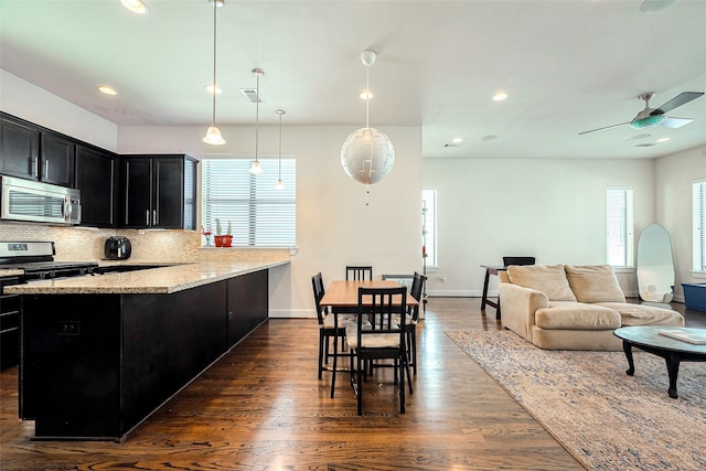 kitchen featuring visible vents, backsplash, ceiling fan, appliances with stainless steel finishes, and dark cabinetry