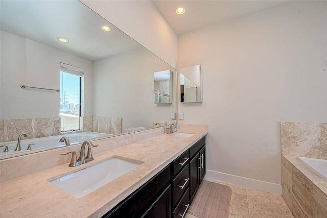 bathroom with a sink, baseboards, a bath, and double vanity