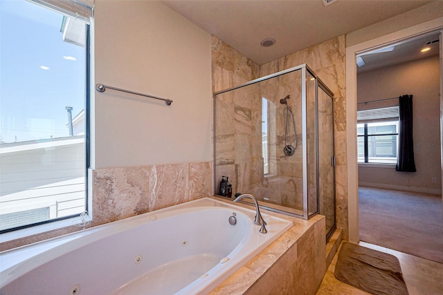 bathroom featuring a shower stall and a tub with jets