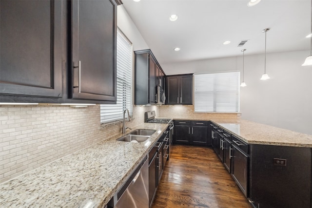 kitchen with a sink, plenty of natural light, stainless steel appliances, and visible vents