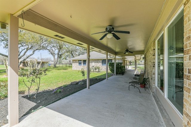 view of patio featuring a ceiling fan and fence