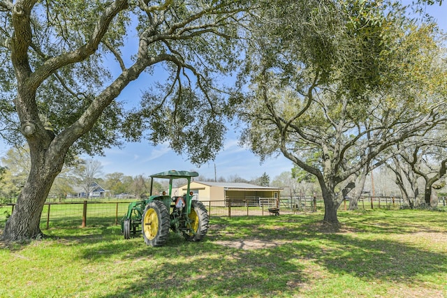 view of yard featuring an exterior structure, an outbuilding, and fence