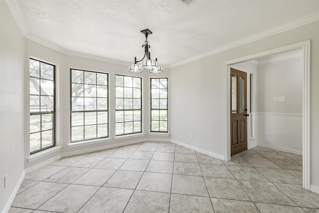 unfurnished dining area featuring light tile patterned flooring, a textured ceiling, crown molding, and an inviting chandelier