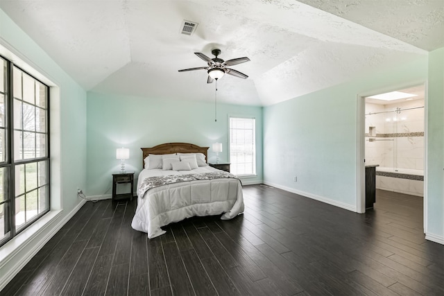 bedroom featuring dark wood-style floors, visible vents, baseboards, and lofted ceiling