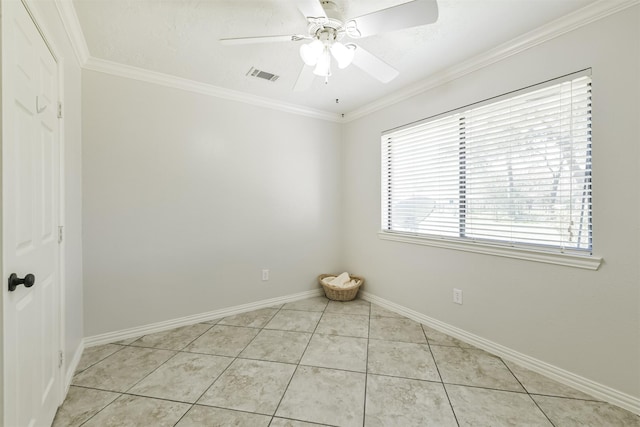 empty room with visible vents, ornamental molding, a ceiling fan, light tile patterned flooring, and baseboards