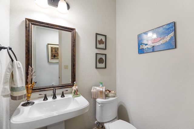 bathroom with toilet and a sink