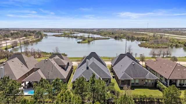 drone / aerial view with a residential view and a water view