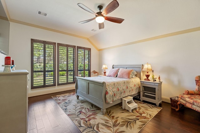 bedroom featuring visible vents, crown molding, lofted ceiling, and wood finished floors