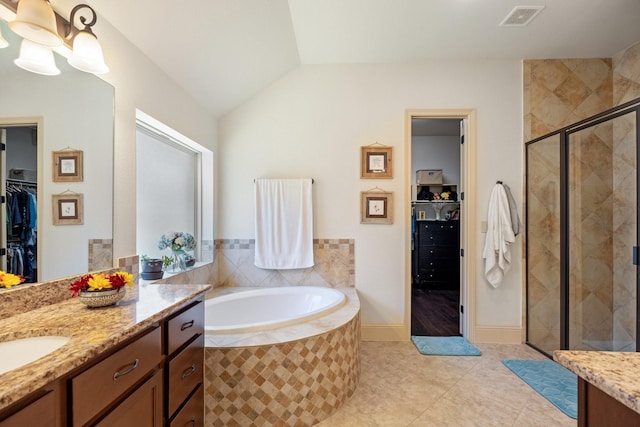 full bathroom with vanity, visible vents, a shower stall, a spacious closet, and a bath