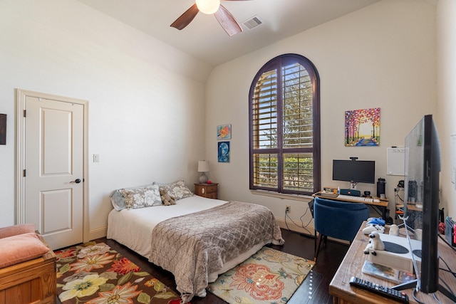 bedroom featuring visible vents, baseboards, wood finished floors, and a ceiling fan