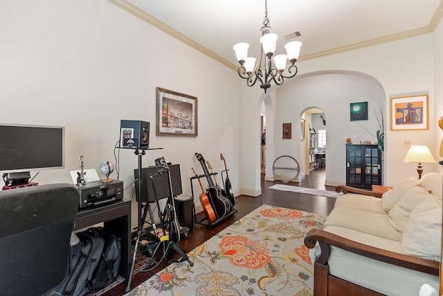 living area with crown molding, wood finished floors, visible vents, and arched walkways