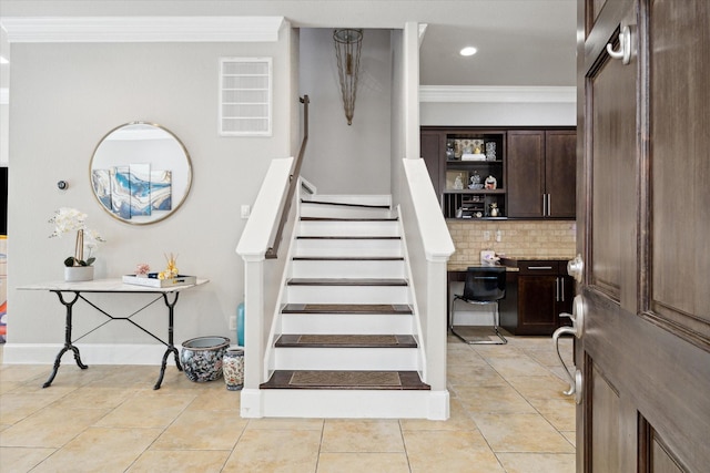 stairway with crown molding, recessed lighting, baseboards, and tile patterned floors