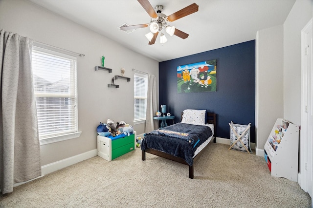 carpeted bedroom with multiple windows, baseboards, and ceiling fan