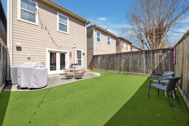 back of property featuring a patio area, cooling unit, french doors, and a fenced backyard